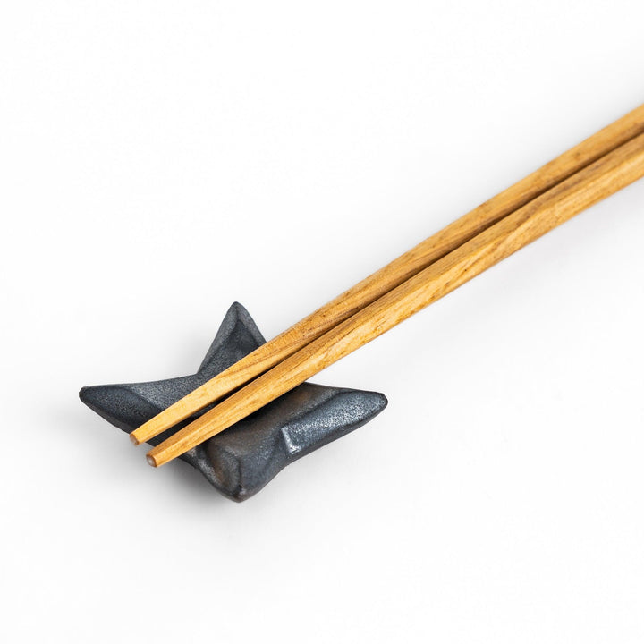 Unique ninja star-shaped chopstick rest with a sleek metallic finish, adding a playful and stylish touch to your dining experience.