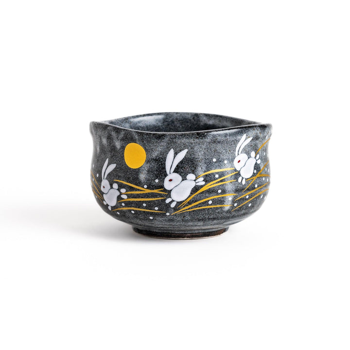Gray matcha bowl with a charming design of rabbits hopping under a full moon, perfect for preparing and enjoying traditional matcha tea.