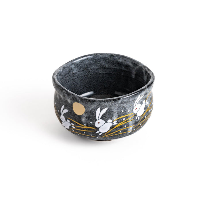 Gray matcha bowl with a charming design of rabbits hopping under a full moon, perfect for preparing and enjoying traditional matcha tea.