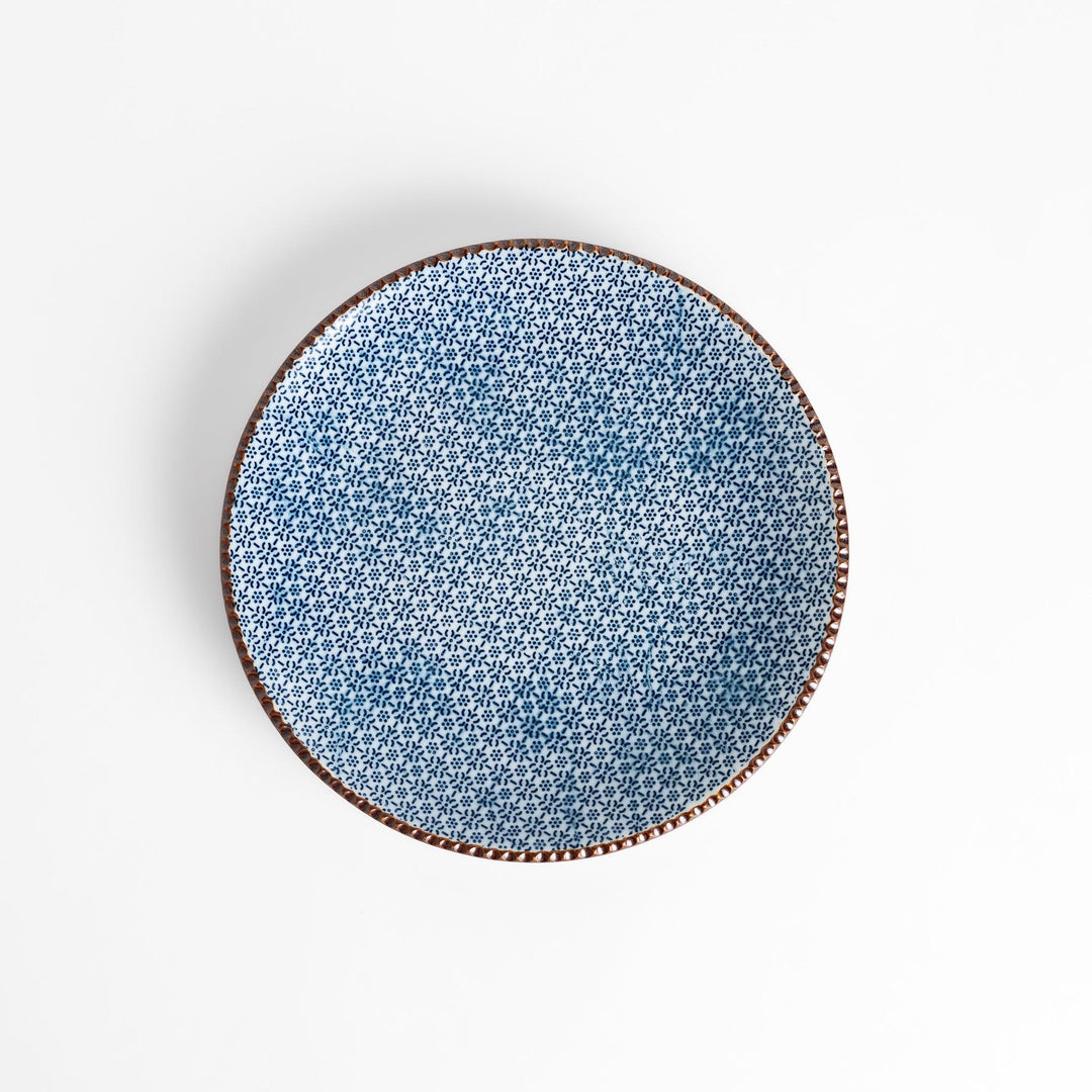 Blue and white floral patterned Salad Plate with a textured dark brown rim, ideal for serving small dishes and adding a touch of elegance to your table.
