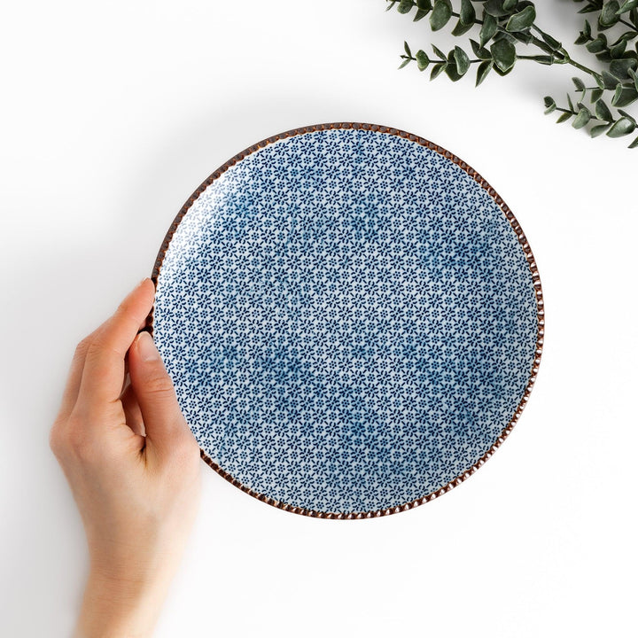 Blue and white floral patterned Salad Plate with a textured dark brown rim, ideal for serving small dishes and adding a touch of elegance to your table.