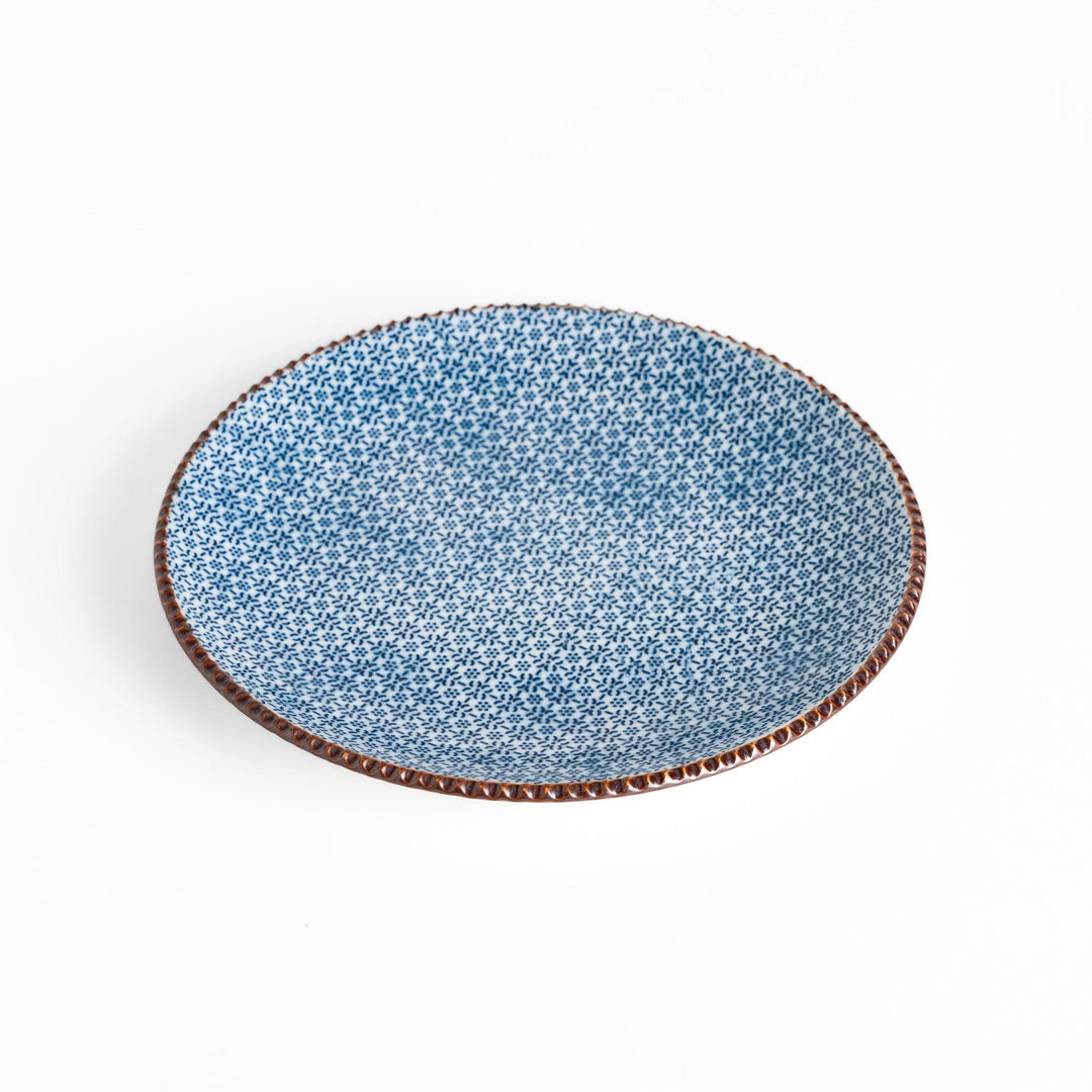 Blue and white floral patterned Salad Plate with a textured dark brown rim, ideal for serving small dishes and adding a touch of elegance to your table.