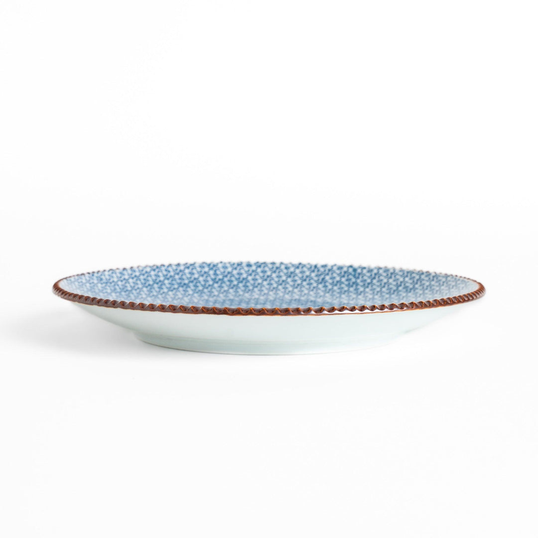 Blue and white floral patterned Salad Plate with a textured dark brown rim, ideal for serving small dishes and adding a touch of elegance to your table.