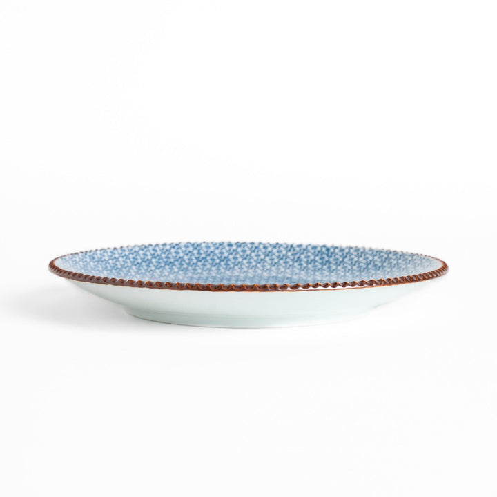 Blue and white floral patterned Salad Plate with a textured dark brown rim, ideal for serving small dishes and adding a touch of elegance to your table.