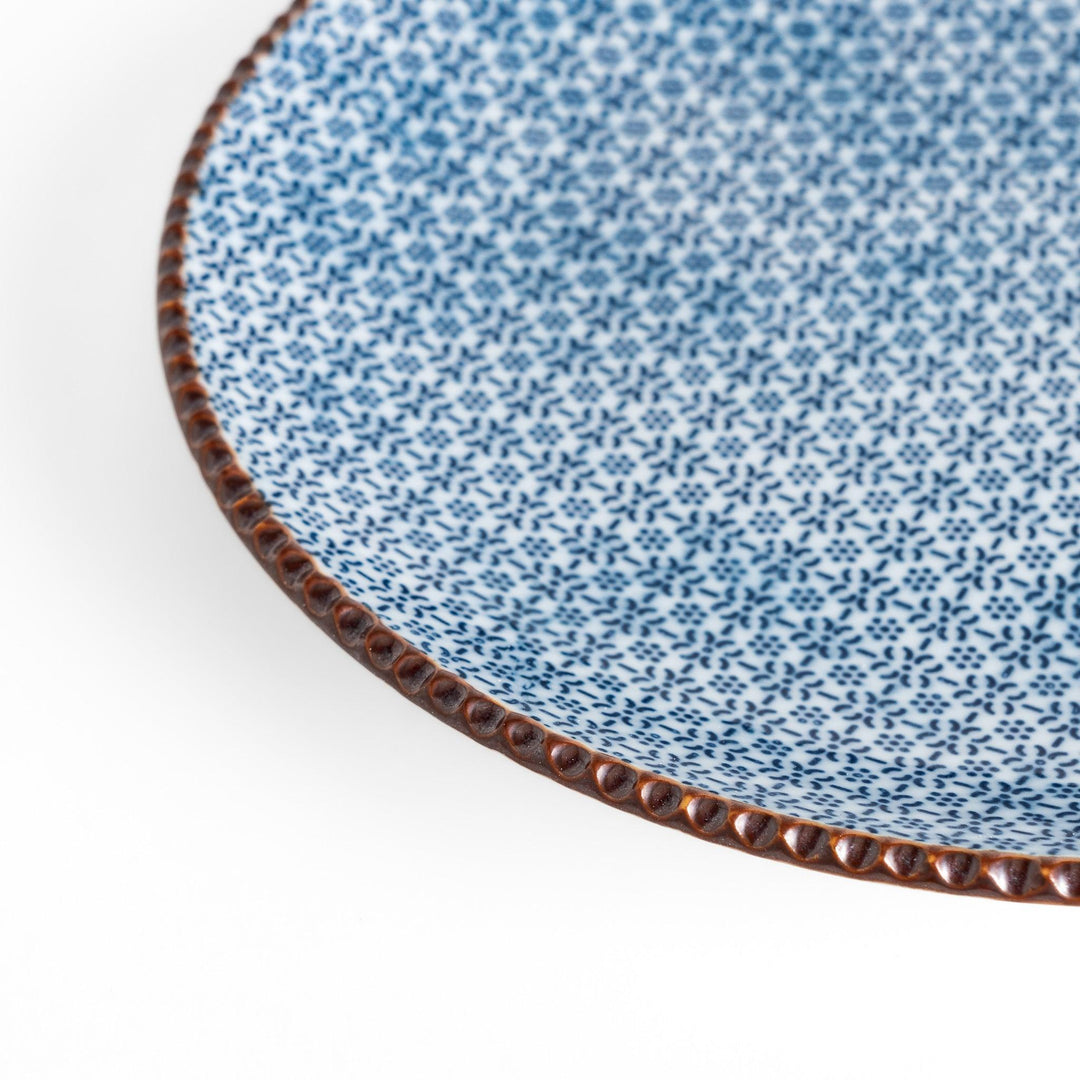 Blue and white floral patterned Salad Plate with a textured dark brown rim, ideal for serving small dishes and adding a touch of elegance to your table.