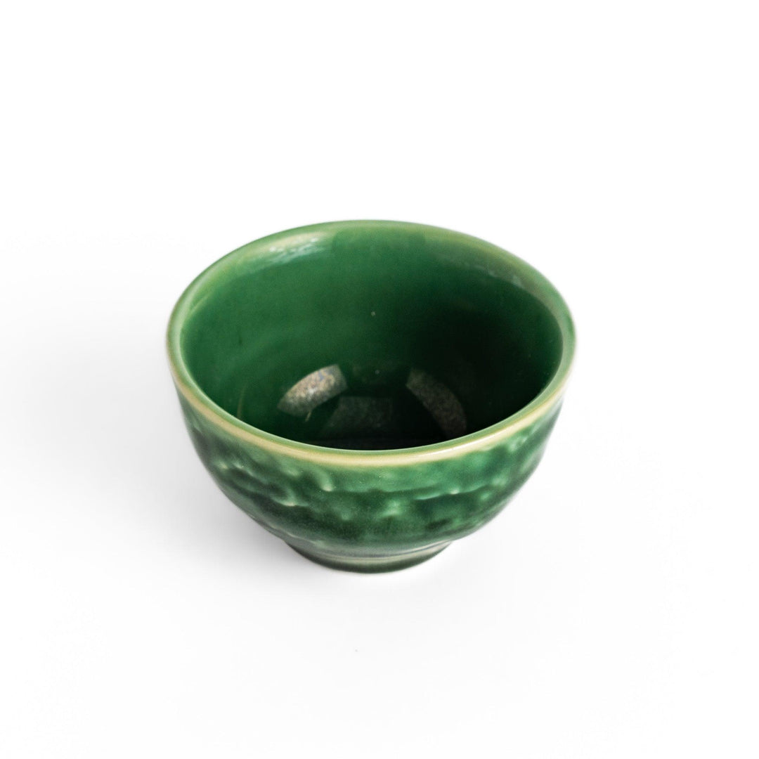 Deep green ceramic sake cup with a glossy textured finish and rounded shape, ideal for enjoying traditional Japanese sake rituals.