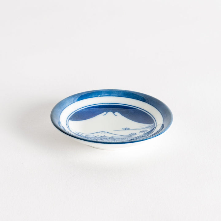 A set of four small, decorative porcelain plates in a gift box, each plate featuring a different dinosaur design in blue and red.