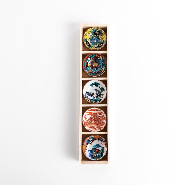 Elegant set of five sake cups with intricate floral and traditional patterns, presented in a wooden box, showcasing timeless Japanese craftsmanship and design.