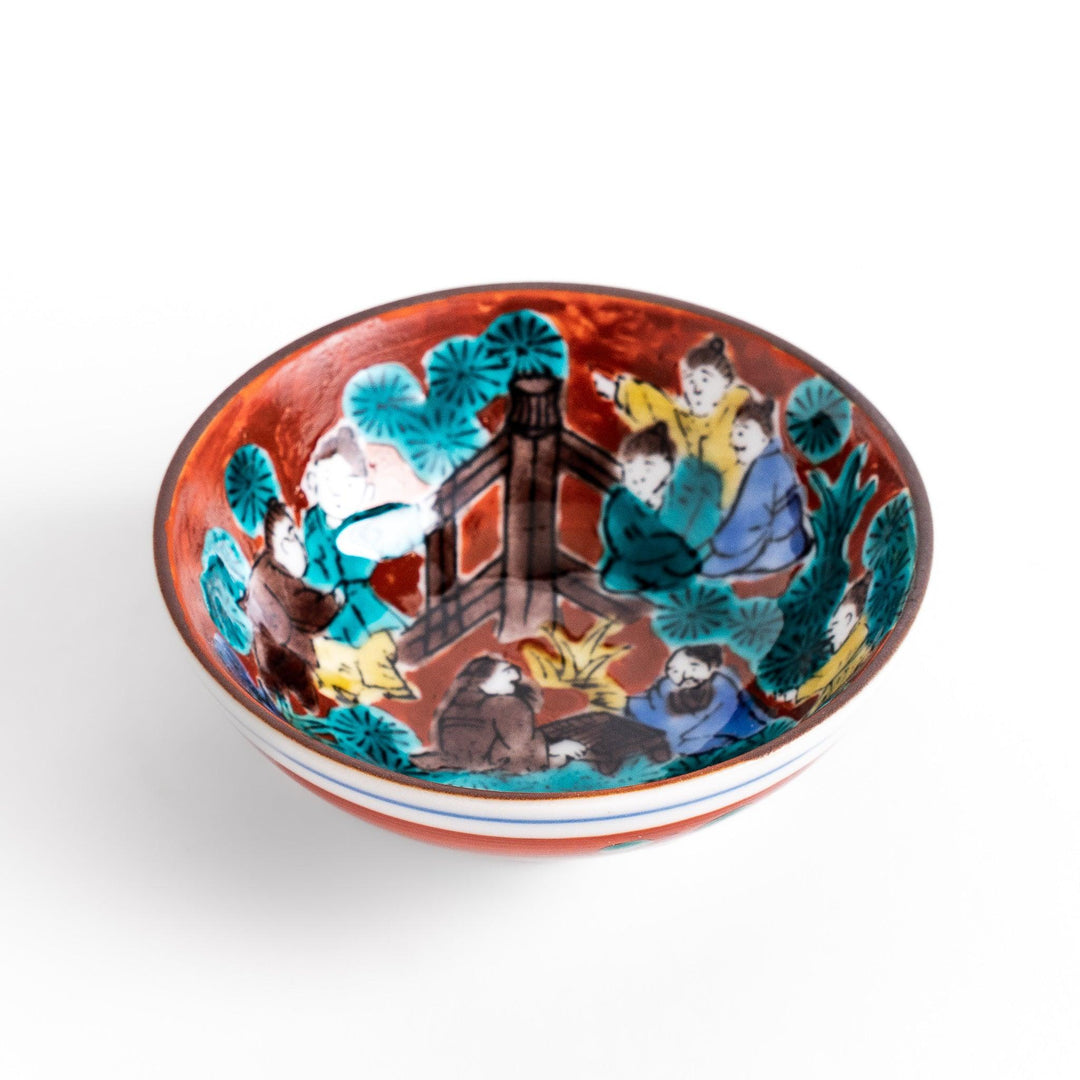 Sake cup with a vivid depiction of a historical scene, featuring figures gathered around a fire, set against a colorful, intricate background.