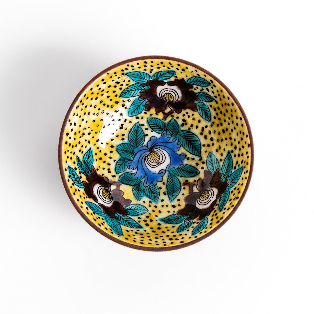 Sake cup featuring a bright yellow background with bold blue and brown flowers, creating a striking and vibrant floral pattern in traditional Japanese style