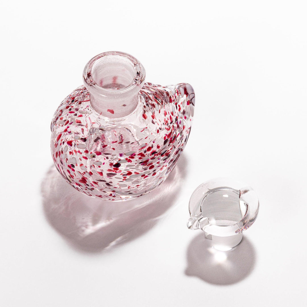 Red and white speckled Ethereal Songbird soy sauce dispenser with a delicate bird design, adding a vibrant touch to your dining experience.