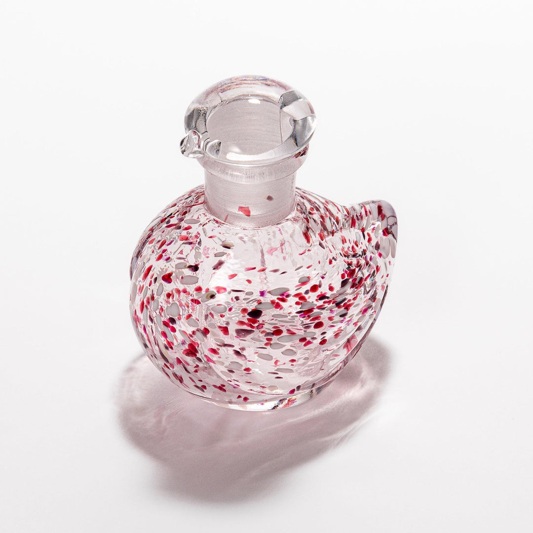 Red and white speckled Ethereal Songbird soy sauce dispenser with a delicate bird design, adding a vibrant touch to your dining experience.