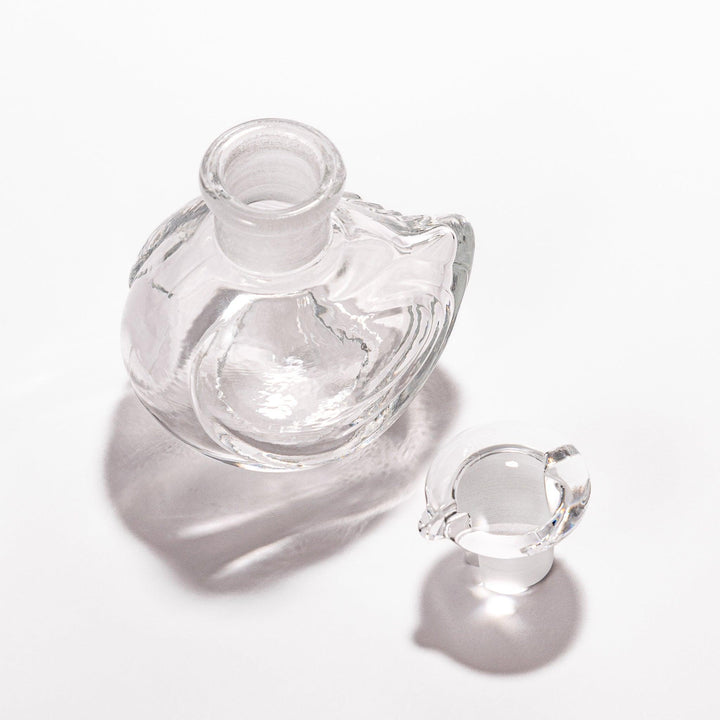 Clear glass Ethereal Songbird soy sauce dispenser with a delicate bird design, perfect for adding elegance and charm to your table setting.