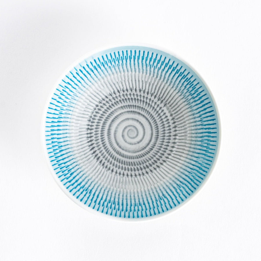 A light blue dessert plate with radiating spiral-striped patterns, viewed from the front.