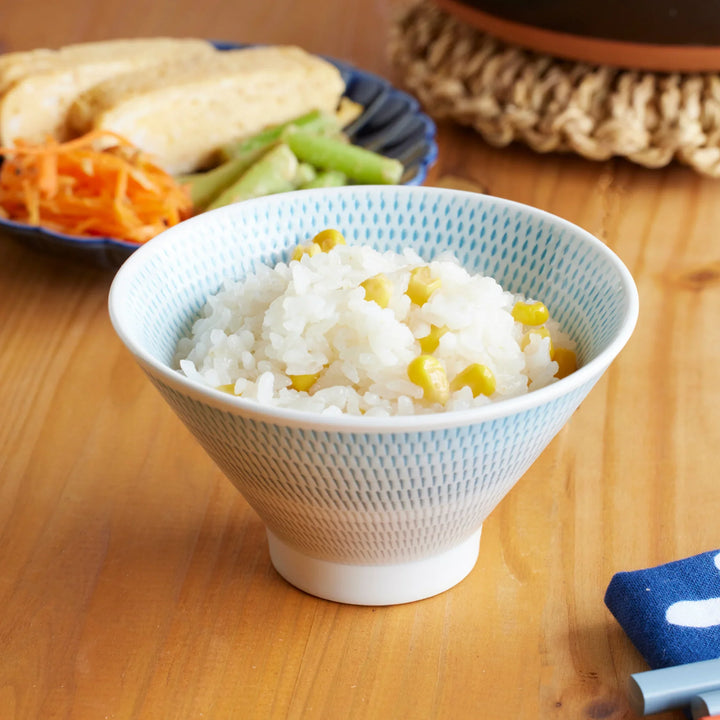 Japanese rice bowl filled with freshly cooked corn rice, served with side dishes, showcasing fluffy donabe-cooked rice for everyday dining.