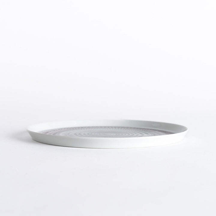 Side view of the plate, showcasing its sleek profile and the vibrant light purple spiral design.