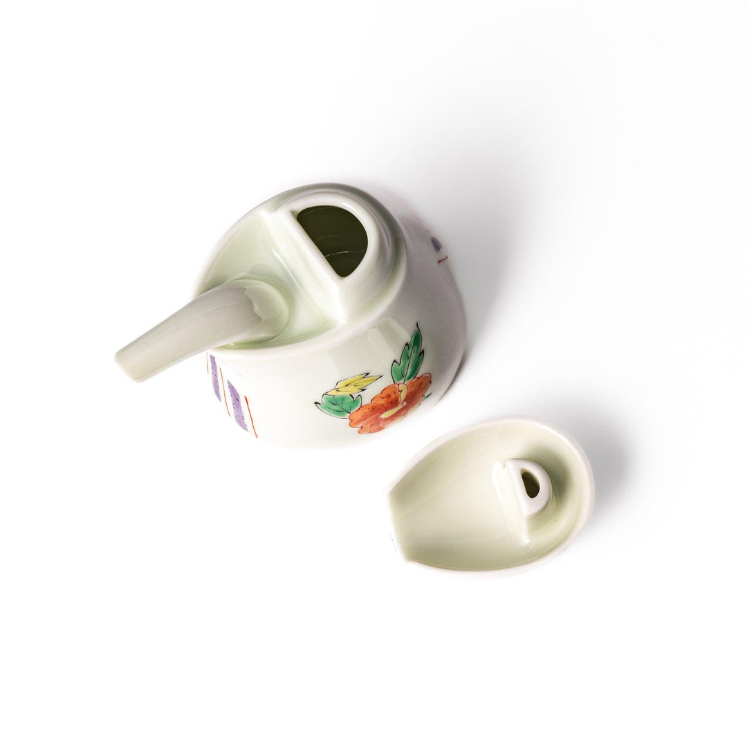A bird-shaped soy sauce dispenser featuring a traditional floral design in red, green, and orange.