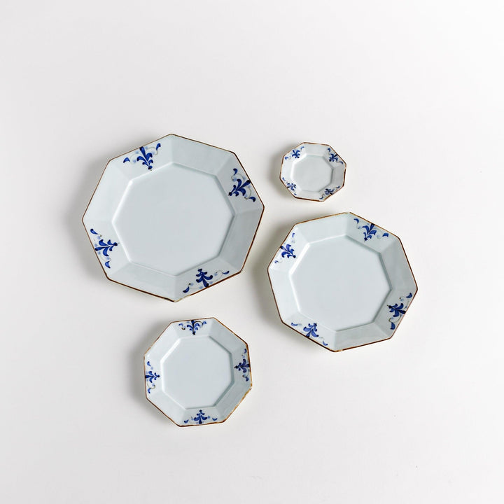Octagonal white porcelain salad plate with a blue floral motif and brown accent trim.