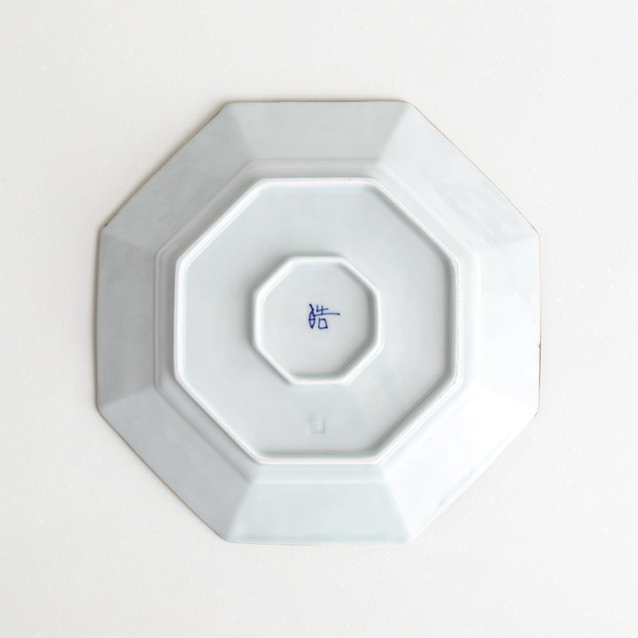 Octagonal white porcelain salad plate with a blue floral motif and brown accent trim.