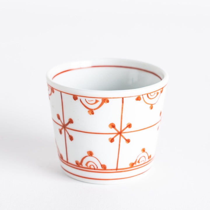 A small white condiment bowl with a delicate blue chrysanthemum and lattice pattern on the exterior.