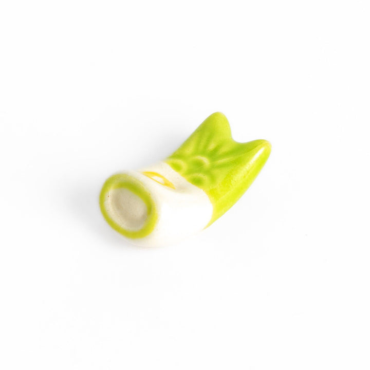 Green carp streamer chopstick rest with a playful yellow eye design.