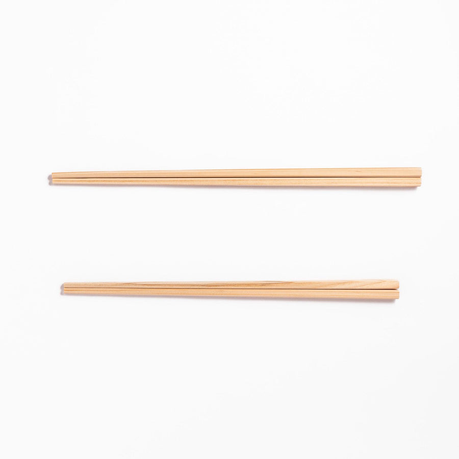 Pair of hinoki wood cooking chopsticks with smooth light wood grain and tapered ends, ideal for Japanese cuisine
