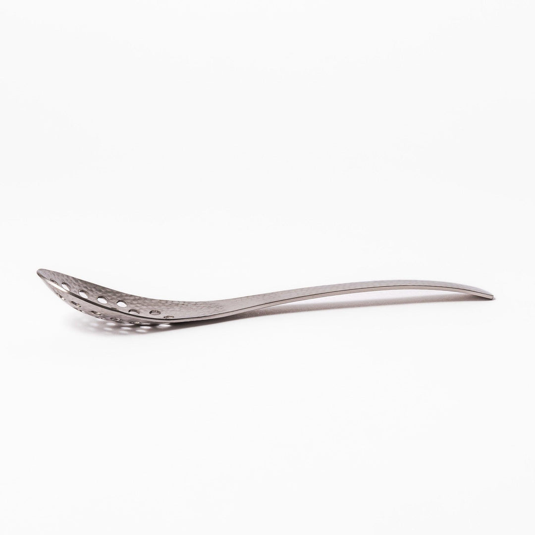 Handcrafted Japanese hammered straining spoon with perforated bowl, ideal for skimming or serving foods while draining excess liquid.