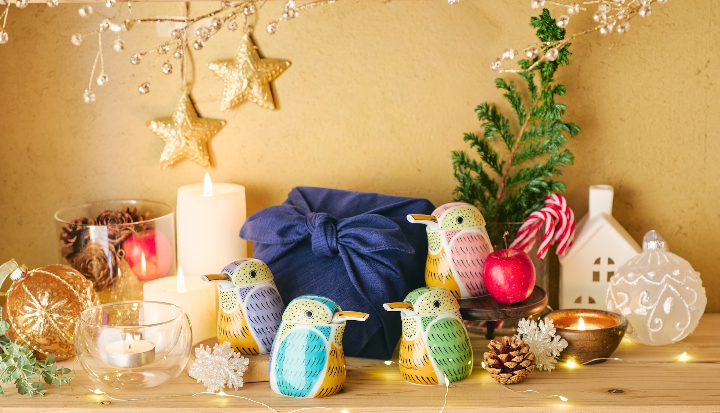 Decorative setup with colorful kingfisher soy sauce dispensers, candles, and festive decorations.