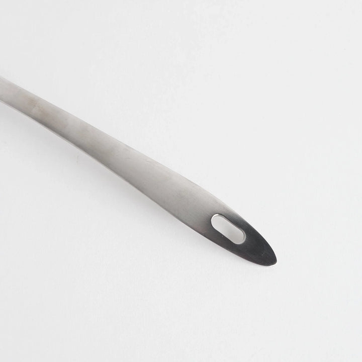 A stainless steel ladle with small drainage holes and a wide, deep scoop, designed for straining while serving.