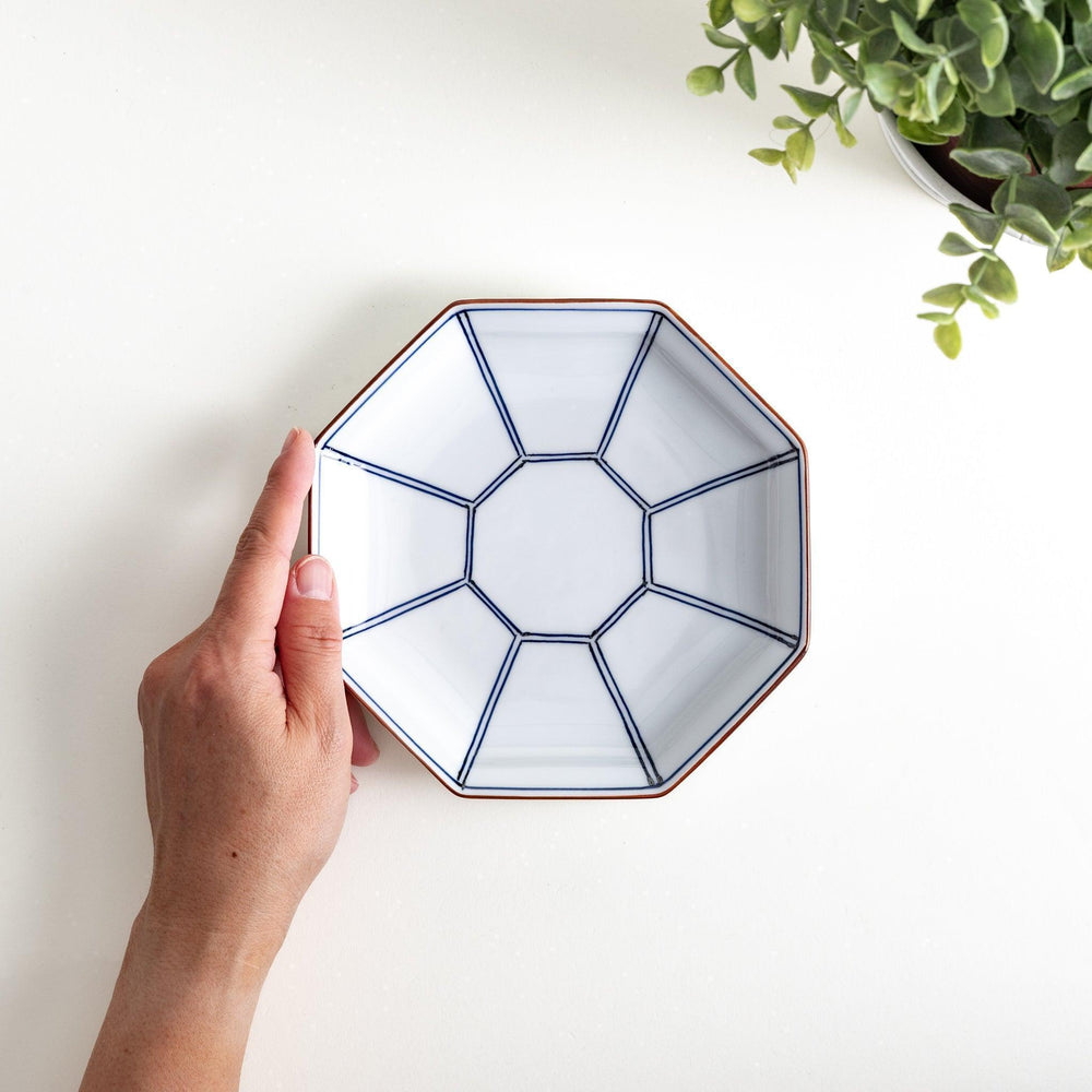 An octagonal porcelain salad plate with a minimalist grid pattern.