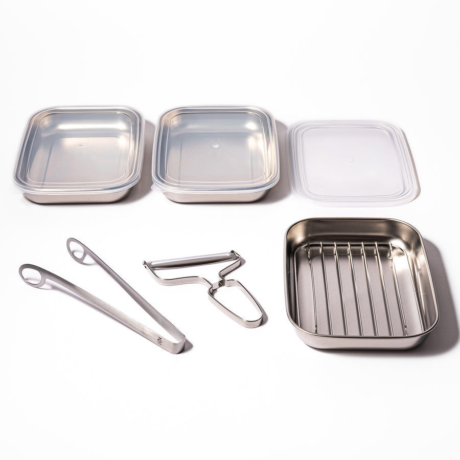 Stainless steel tonkatsu frying set featuring prep trays with lids, draining rack, tongs, and peeler, designed for efficient food prep and crispy fried dishes.
