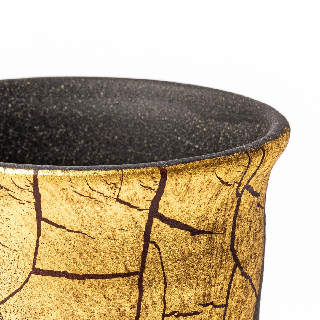 Kintsugi-inspired black Kutani sake carafe with striking gold crackle pattern, showcasing traditional Japanese aesthetics and modern ceramic design.