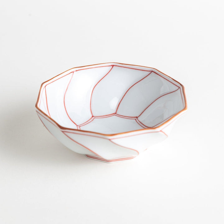 Deep white octagonal dessert bowl with a petal design, outlined in blue or red and finished with a brown rim.