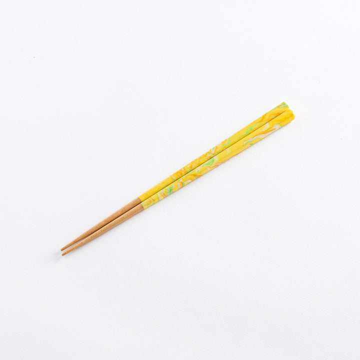 Chopsticks featuring marbled yellow, orange, and green tips with wooden shafts. A vibrant and stylish addition to any dining experience.