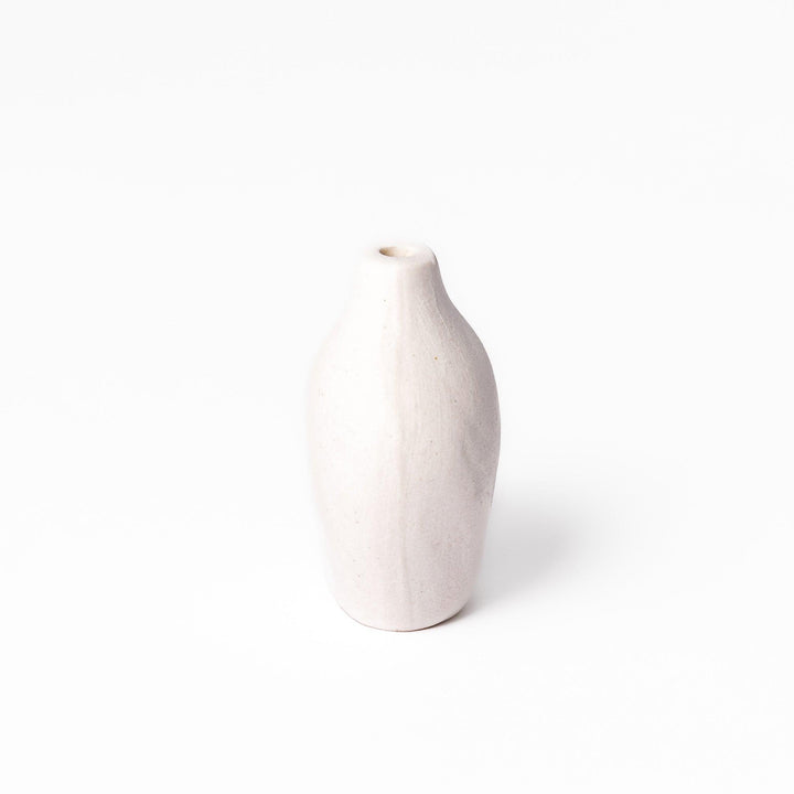 Minimalist white ceramic bud vase with a pear-shaped silhouette and narrow opening, perfect for displaying a single flower or small arrangement.