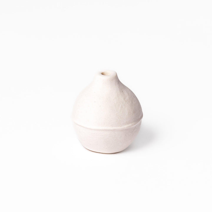 Minimalist white ceramic bud vase with an orb-like shape and subtle center ridge, ideal for adding soft, sculptural charm to any small floral display.