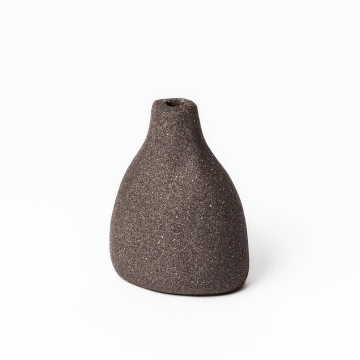 Minimalist dark ceramic bud vase with a teardrop silhouette and textured surface, perfect for adding earthy elegance to floral or dried arrangements.