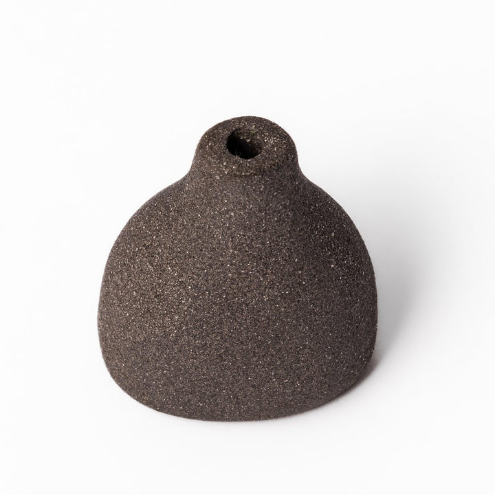 Minimalist dark ceramic bud vase with a teardrop silhouette and textured surface, perfect for adding earthy elegance to floral or dried arrangements.