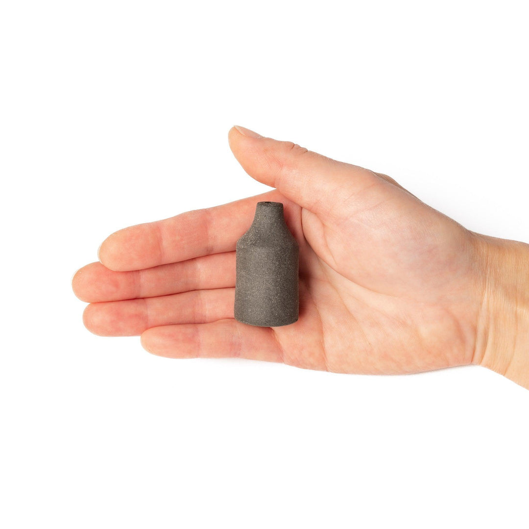 Minimalist dark ceramic bud vase with a cylindrical silhouette and matte finish, perfect for showcasing single stems or dried botanicals.