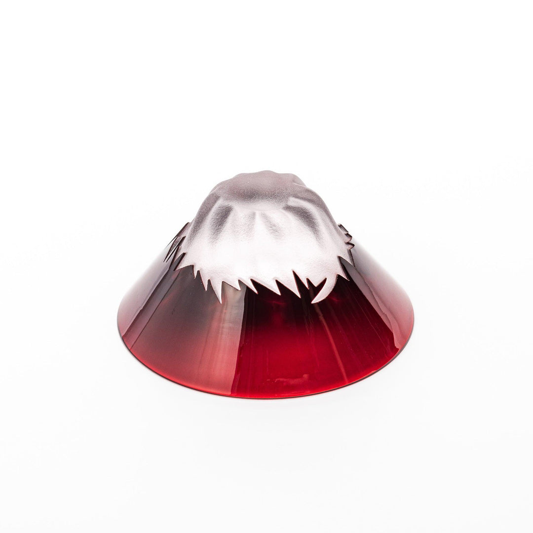 Red glass sake cup in the form of Mount Fuji, complete with a frosted snowcap design, crafted for elegant Japanese-style celebrations.