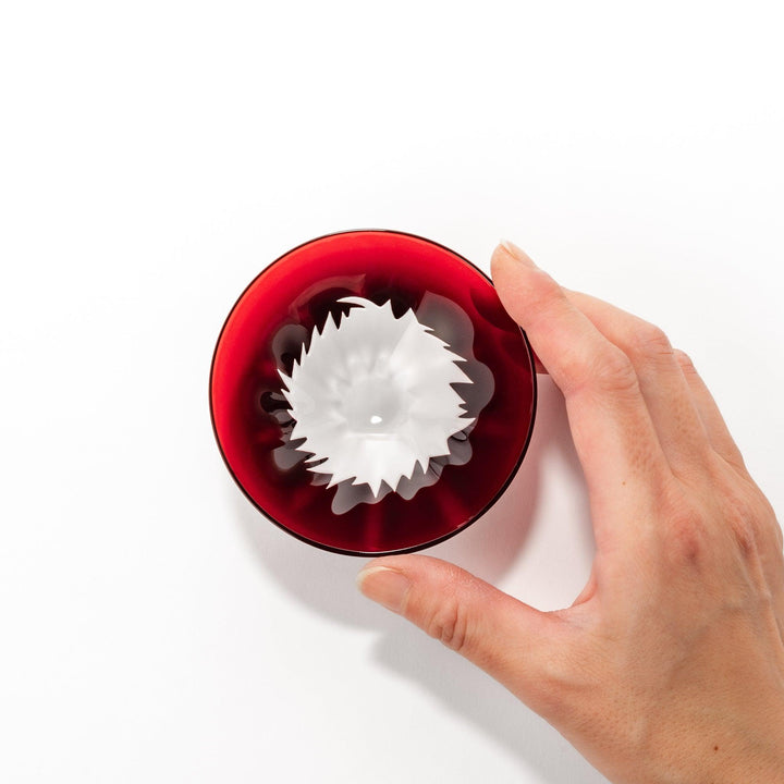 Red glass sake cup in the form of Mount Fuji, complete with a frosted snowcap design, crafted for elegant Japanese-style celebrations.