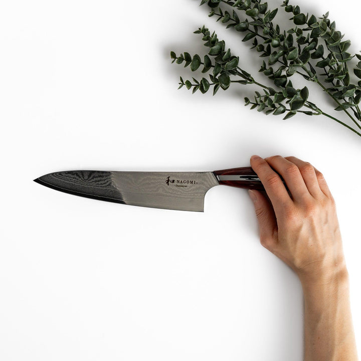A high-quality Damascus chef's knife with a beautifully patterned blade and a striped wooden handle, offering both elegance and precision for your culinary tasks.
