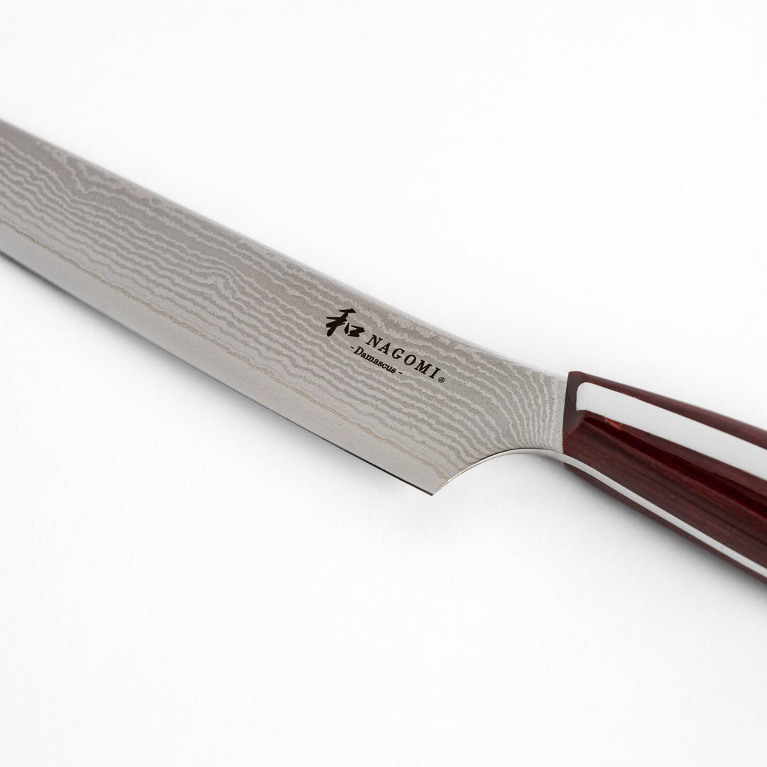 A high-quality Nagomi Damascus utility knife with a beautifully patterned blade and a striped wooden handle, offering excellent precision for everyday kitchen tasks.