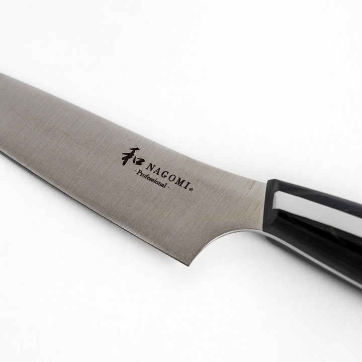 A Nagomi Professional utility knife with a sleek, sharp blade and a modern striped handle, offering precision and comfort for all your kitchen tasks.