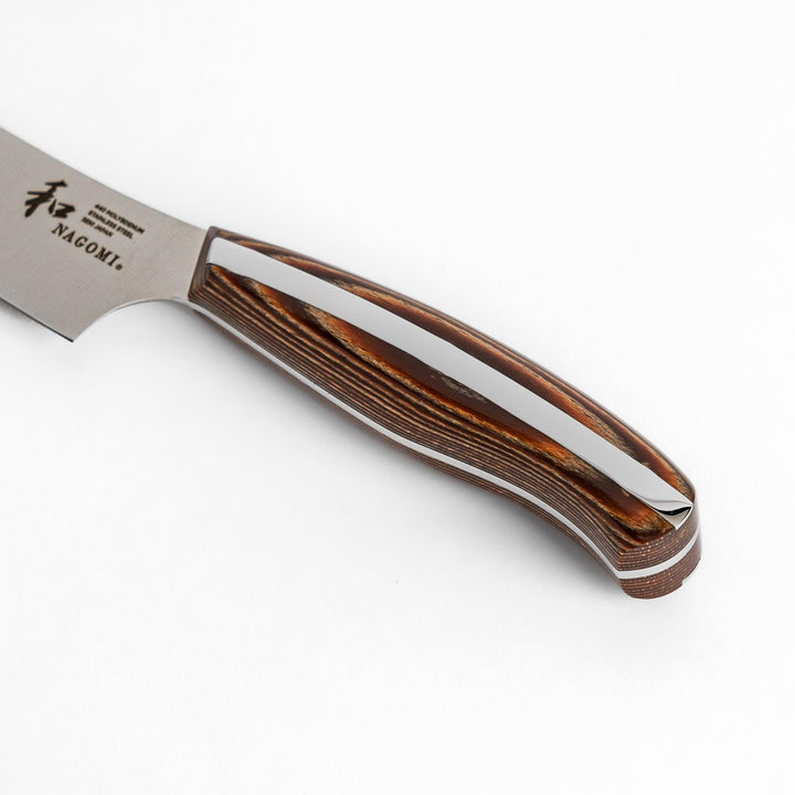 A Nagomi utility knife featuring a sharp, durable blade and a beautifully crafted striped wooden handle, designed for precision and comfort in various kitchen tasks.