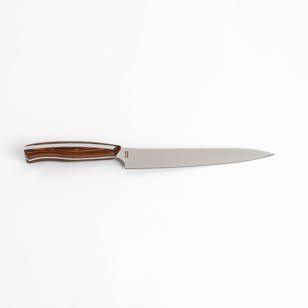 A Nagomi utility knife featuring a sharp, durable blade and a beautifully crafted striped wooden handle, designed for precision and comfort in various kitchen tasks.
