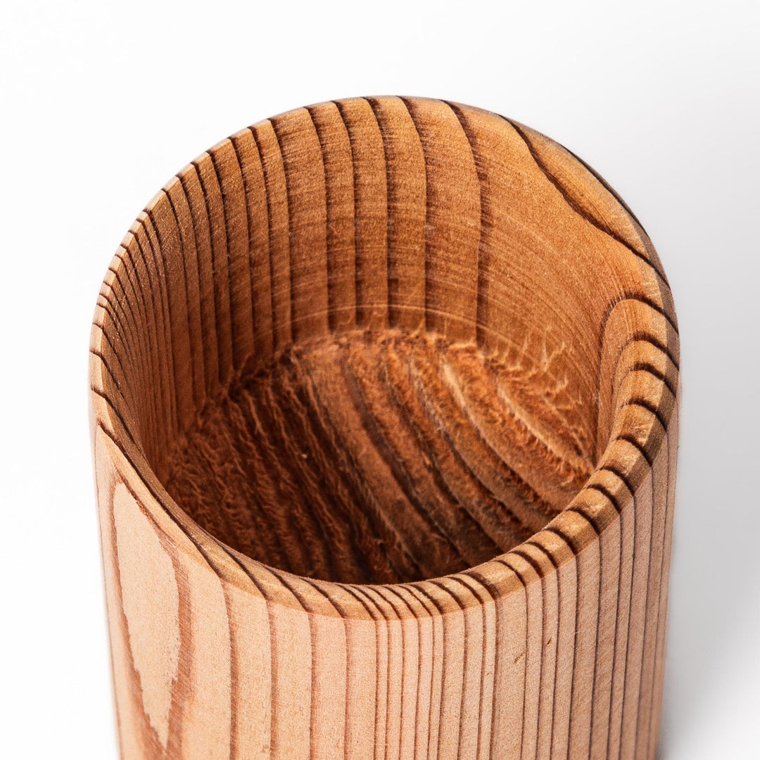 Natural cedar sake cup with a smooth curved rim and vertical grain lines, offering a warm, aromatic touch to your traditional Japanese drinkware.
