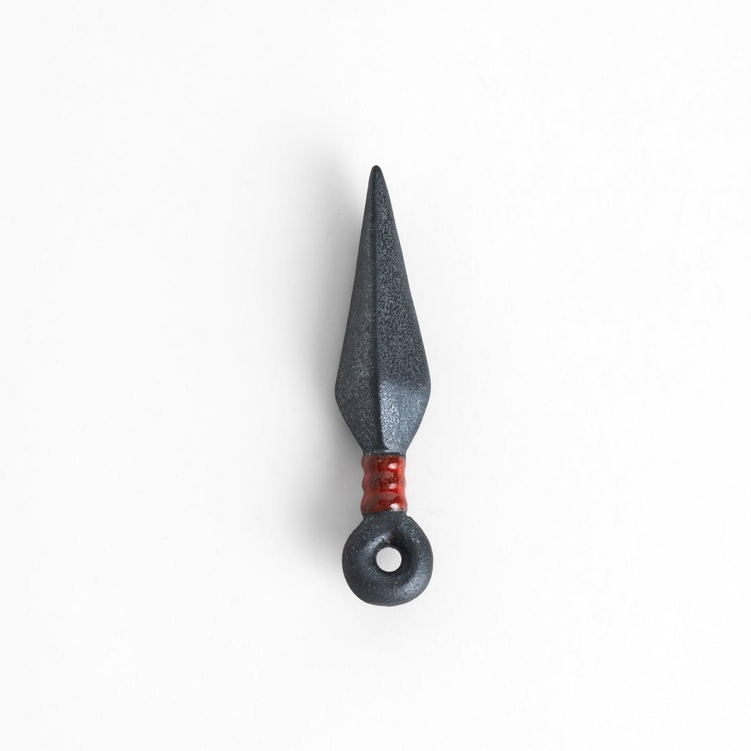 Sleek ninja blade-shaped chopstick rest with a metallic finish and red accent, adding a bold and unique touch to your dining experience.