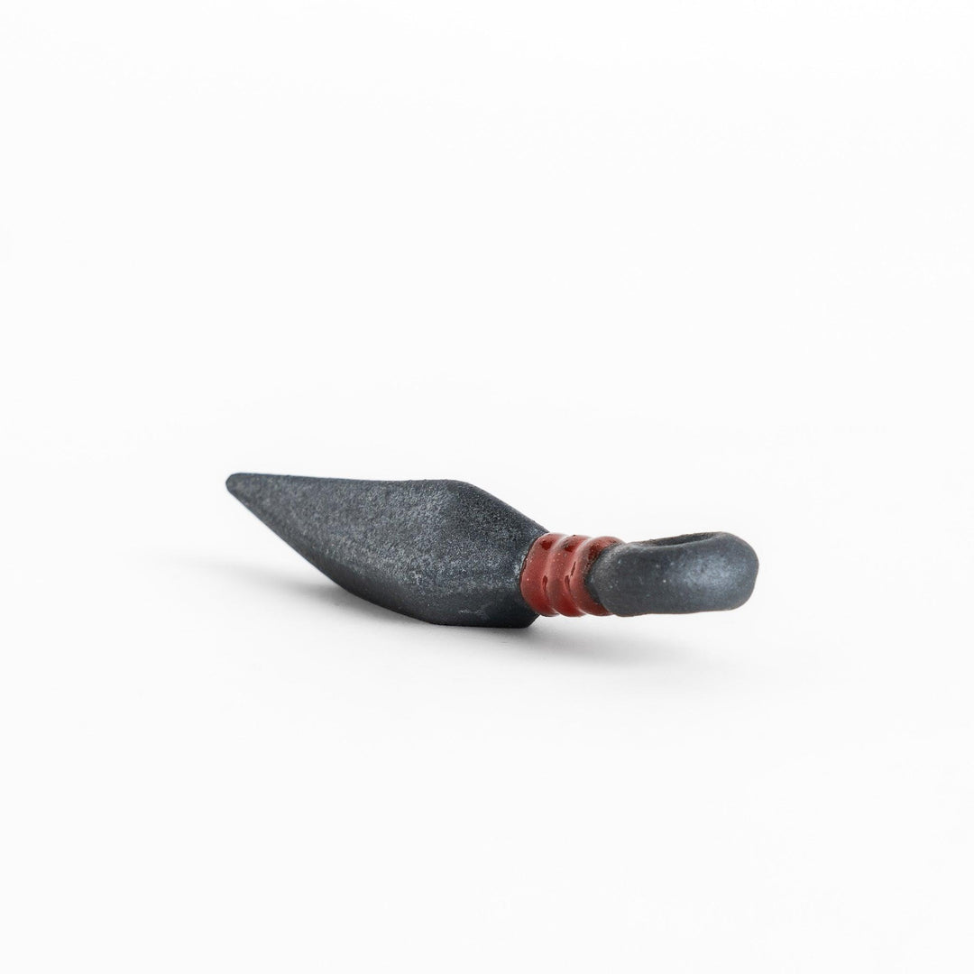 Sleek ninja blade-shaped chopstick rest with a metallic finish and red accent, adding a bold and unique touch to your dining experience.