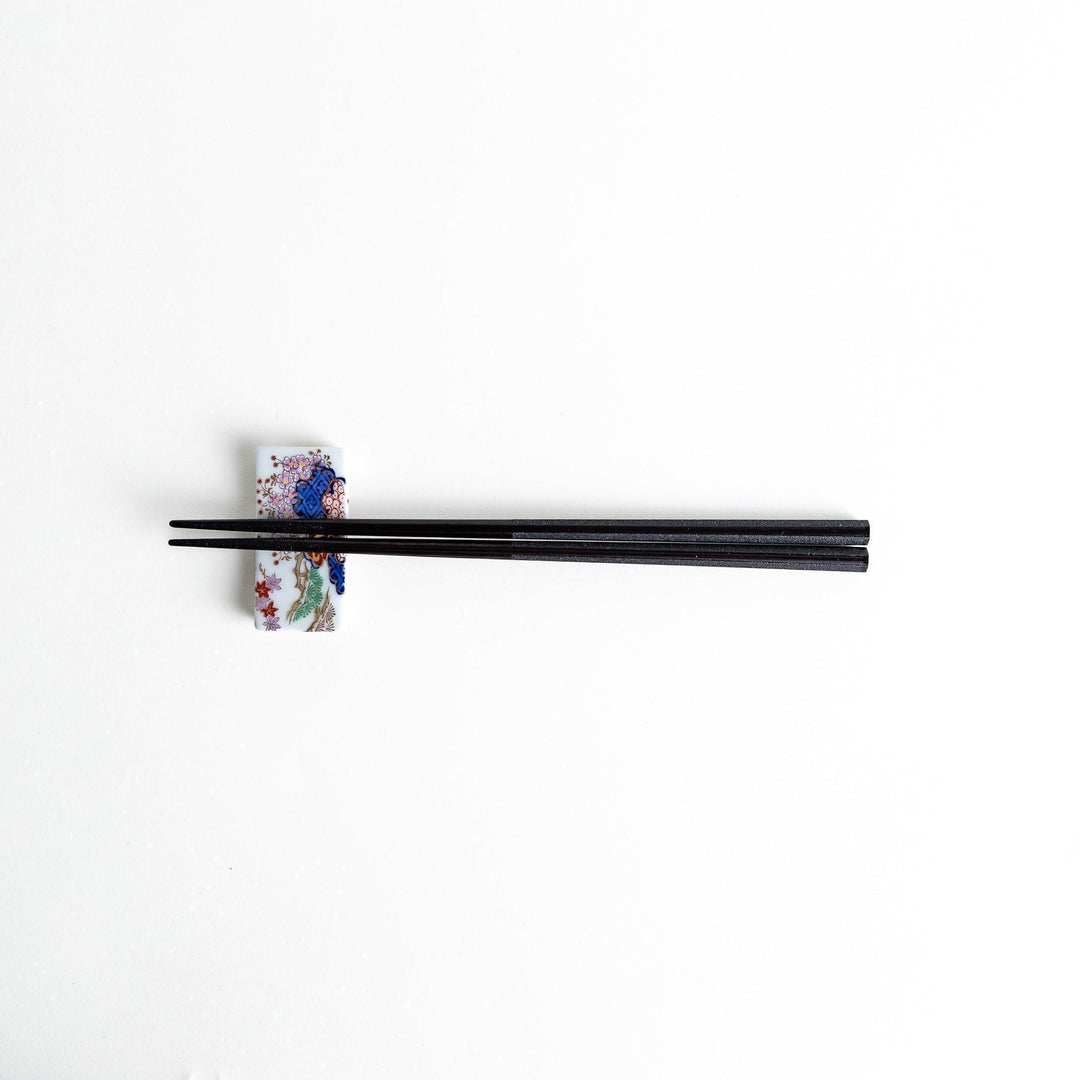 Octagonal wooden chopsticks with a brown tone, finished with a textured grain. Available in red or black.